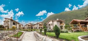 a row of houses with a hill in the background at Intiterra Apart Hotel Villas in Urubamba