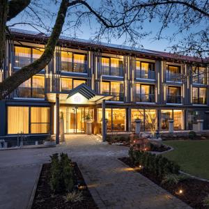 an exterior view of a building with lights at Hotel Riedenburg in Bad Füssing