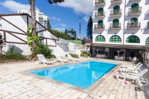 a swimming pool in front of a hotel at Hotel Tannenhof in Joinville