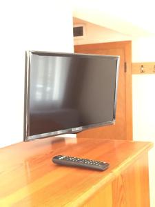 a computer monitor and a remote control on a desk at Üstün Apart in Marmaris