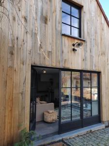 a wooden building with a large sliding glass door at Annex in Oudenaarde