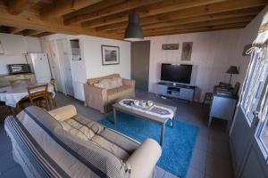 een woonkamer met een bank en een tafel bij La cabane 26 D in Andernos-les-Bains