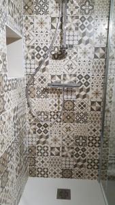 Un baño con ducha con pared de azulejos. en Gîte "L'Escapade Marine", en Cancale 23 fotos más