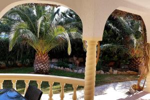 a view of a porch with a palm tree at Casa Del Sol in L'Ametlla de Mar