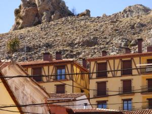 a building in front of a mountain at Apartamento Las Eras in Camarena de la Sierra