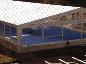 a chain link fence with a white tent at Apartamento Las Eras in Camarena de la Sierra