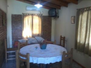 a room with a table with chairs and a couch at La Casa de Ana in Bialet Massé