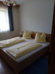 a bed with two pillows on it in a bedroom at Berningerhof in St. Wolfgang