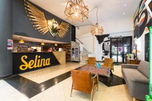 a dining room with a restaurant with an eagle on the wall at Selina Medellin in Medellín