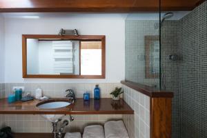 a bathroom with a sink and a mirror and a shower at CURNIOLA 21 in Ciutadella +27 photos