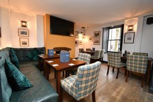 a living room with a couch and a table and chairs at Rose and Crown Hotel in Carmarthen