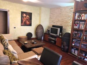 a living room with a couch and a tv at Casa M. in Candelaria