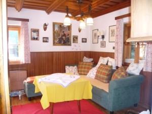 a living room with a couch and a table at Waldnerhütte in Hermagor