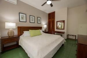 1 dormitorio con 1 cama y ventilador de techo en Club del Mar Oceanfront, en Jacó