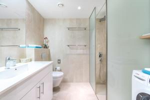 a bathroom with a toilet sink and a shower at Rotermann Square view Apartment in Tallinn