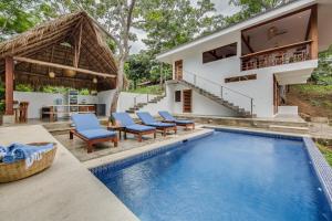 a villa with a swimming pool and a house at Verdad Nicaragua in San Juan del Sur