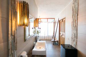 a bathroom with a sink and a mirror at Punta Duarte Garden Inn in Los Duarte