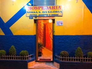 a door to a building with a blue and yellow at Hospedaria Nossa Senhora da Glória in Petrópolis
