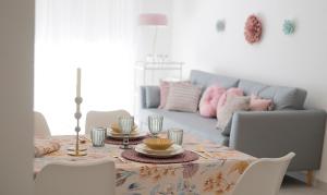 a living room with a table and a couch at City Valencia Beach 360 in Valencia