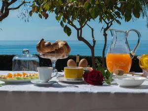 a table with a breakfast of eggs and orange juice at Agrilea in Santo Stefano al Mare