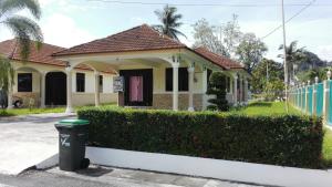 a house with a trash can in front of it at Desa Tunjung Homestay in Kangar