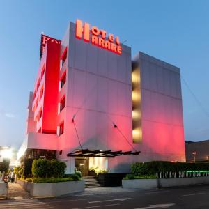 a hotel with a red sign on the front of a building at Hotel Harare in Mexico City