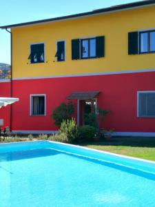 a house with a swimming pool in front of a building at Varavventura in Riccò del Golfo di Spezia