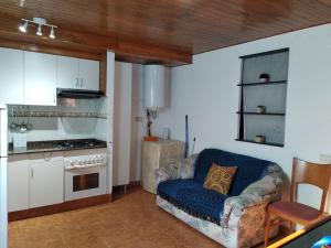 a living room with a couch and a kitchen at Apartamentos loli in Berga