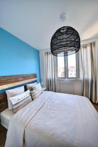 A bed or beds in a room at Apparts Seasons - Saint Étienne Centre - Gare Chateaucreux