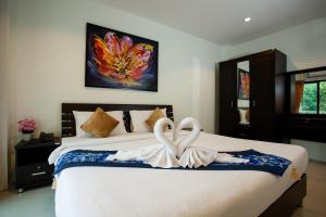 A bed or beds in a room at The Wave Hotel Patong SHA