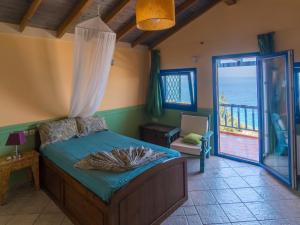 a bedroom with a bed and a view of the ocean at Ocea Retreat in Karlovasi
