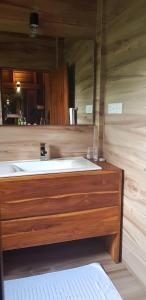 a bathroom with a tub and a large mirror at Wilpattu Tree House in Wilpattu