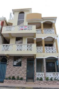 a building with a balcony with a flag on it at Elisa Furnished Apartments (Puerto Plata City) in San Felipe de Puerto Plata