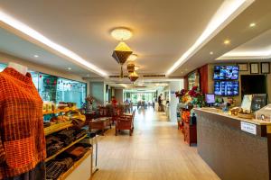 a store with a store front with a counter and a store at Rung Aroon Hotel By Le Siri in Chiang Mai