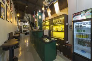 a bar with a green counter and some bar stools at Hanoi EcoStay 2 hostel in Hanoi