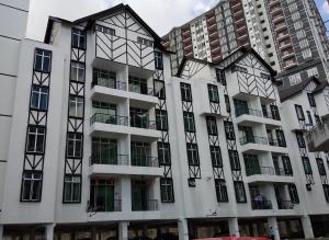 an apartment building with black and white windows at Cameron Cactus Apartment @ Pangsapuri Kaktus in Brinchang