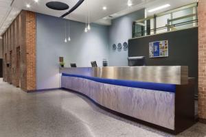 an office lobby with a blue and silver reception counter at Travelodge by Wyndham Montreal Centre in Montreal