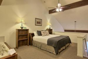 a bedroom with a bed and a ceiling fan at 209 Pointes North Inn in Charlevoix +20 photos