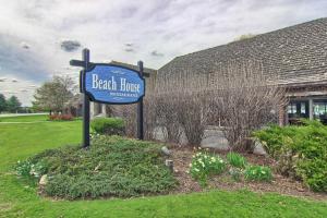 a sign for a beach huts restaurant in front of a building at 620 Disciples Village in Boyne Falls