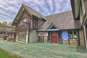 an old building with a red door on a street at 620 Disciples Village in Boyne Falls