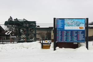 a sign in the snow in front of a train station at 620 Disciples Village in Boyne Falls