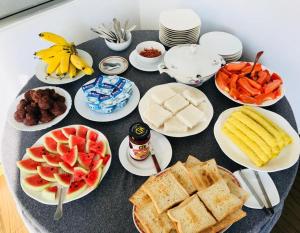 a table with plates of food and fruit on it at Susee Villa in Bentota
