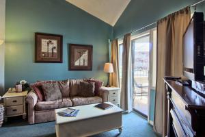 a living room with a couch and a table at 210 Pointes North Inn in Charlevoix