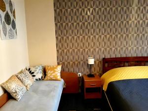 a hotel room with a bed and a couch at Town Center Studio Apartment in Daugavpils