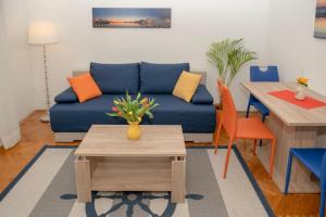 a living room with a blue couch and a table at Bella Vita in Split