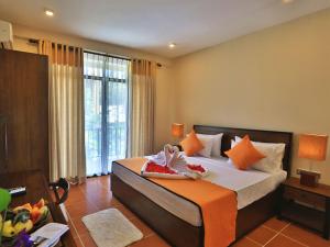 a bedroom with a large bed and a large window at ROYAL KASHYAPA - Habarana in Habarana +11 photos