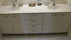 a bathroom with two sinks and two mirrors at Palm Island Villa 2 Bedroom Deluxe Villa in Cape Haze