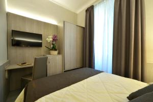 Een bed of bedden in een kamer bij Hotel Lamberti