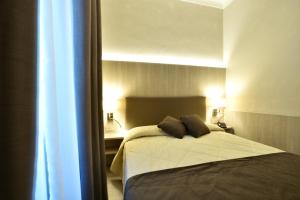 Кровать или кровати в номере Hotel Lamberti