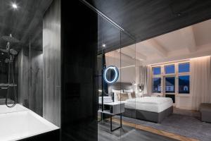 a bathroom with a tub and a sink and a mirror at Pytloun Boutique Hotel Prague in Prague